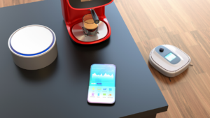 Kaffemaskin, smarttelefon, ruter og robotstøvsuger i et rom 